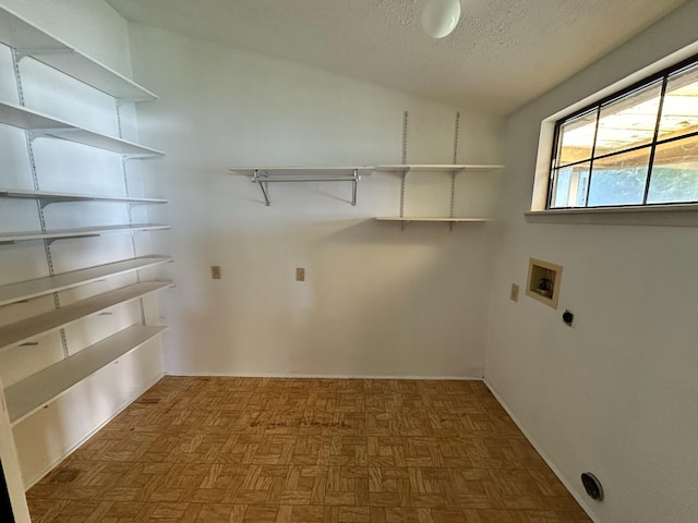 laundry area with washer hookup, laundry area, and a textured ceiling