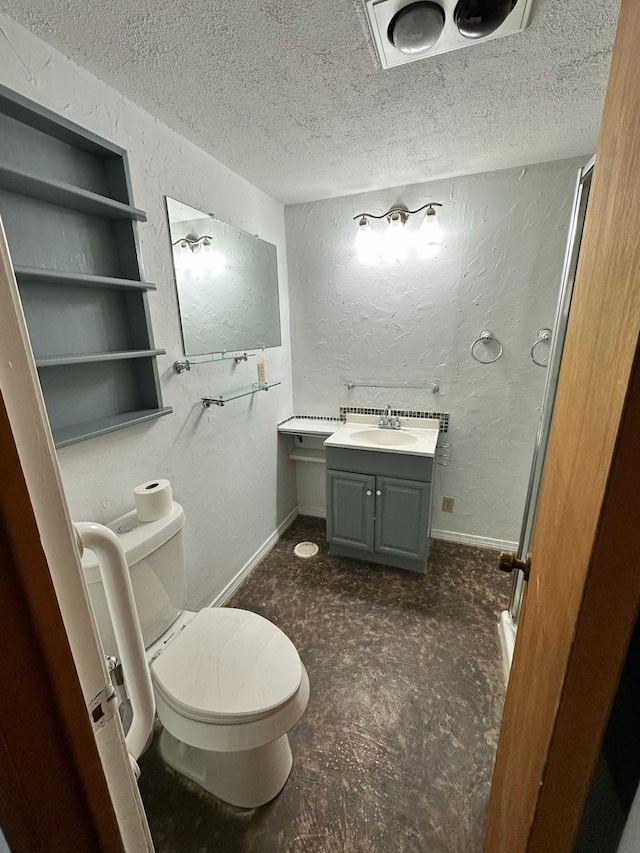 bathroom with toilet, a textured ceiling, vanity, and a textured wall