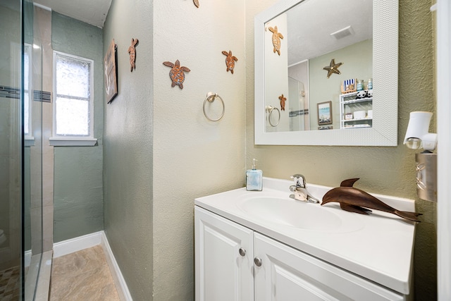 full bath featuring visible vents, vanity, a textured wall, and a shower with shower door