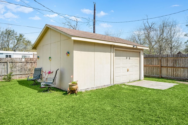 view of outbuilding with driveway, an outdoor structure, and fence