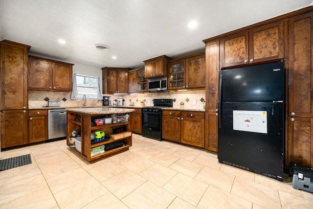 kitchen with light stone counters, visible vents, open shelves, black appliances, and tasteful backsplash