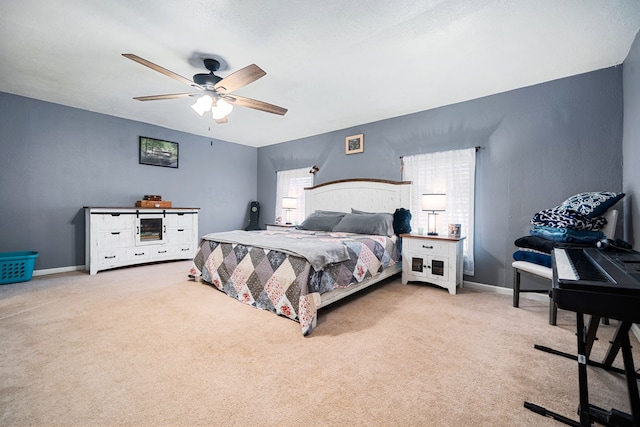 carpeted bedroom with a ceiling fan and baseboards