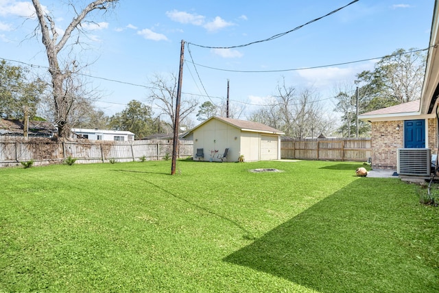 view of yard with central air condition unit, an outdoor fire pit, a fenced backyard, an outdoor structure, and a garage