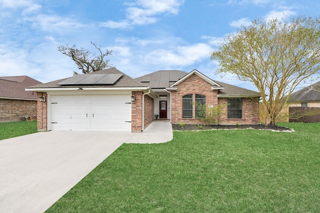 ranch-style home featuring brick siding, a garage, concrete driveway, and a front yard