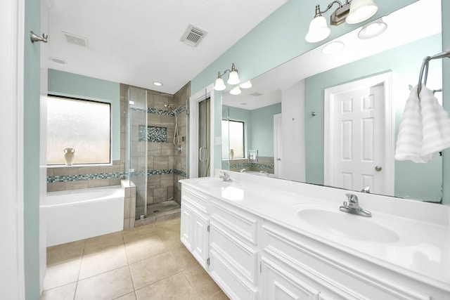 full bath with tile patterned flooring, visible vents, a stall shower, and a sink