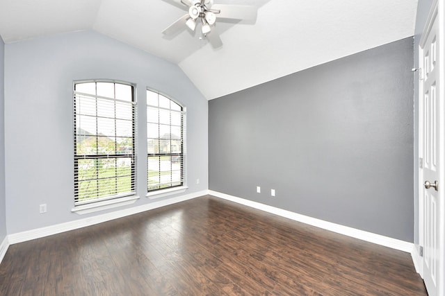 unfurnished room featuring dark wood-style floors, baseboards, ceiling fan, and vaulted ceiling