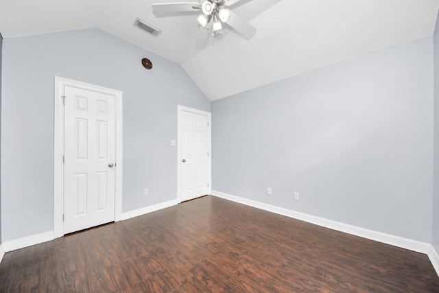 unfurnished bedroom featuring lofted ceiling, baseboards, visible vents, and dark wood-style flooring