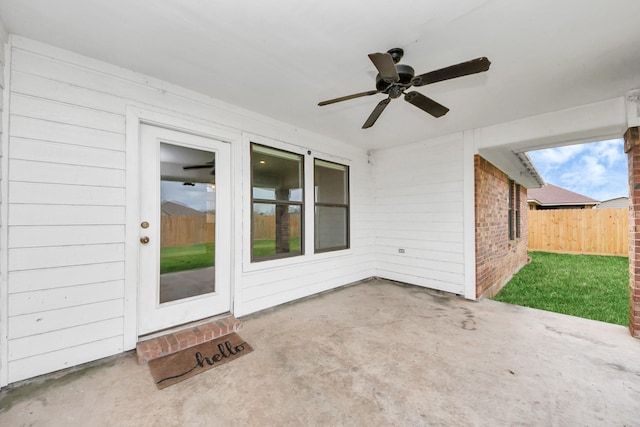 view of patio / terrace with ceiling fan and fence