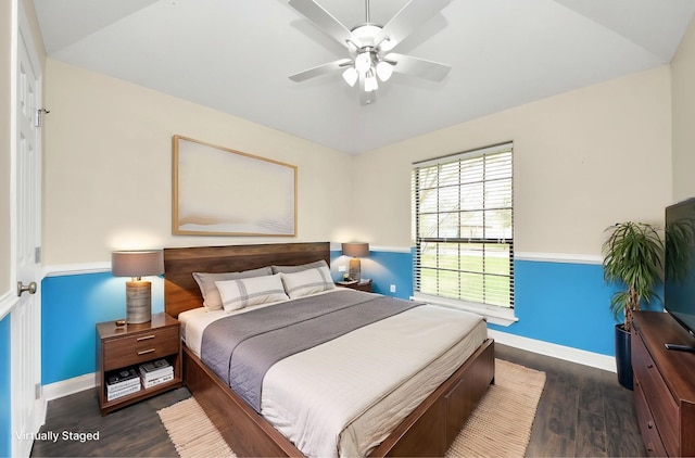 bedroom featuring ceiling fan, baseboards, and wood finished floors