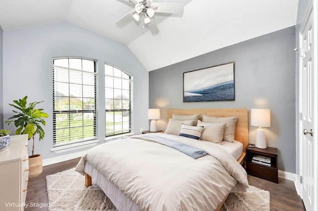 bedroom featuring baseboards, a ceiling fan, lofted ceiling, and dark wood-style flooring