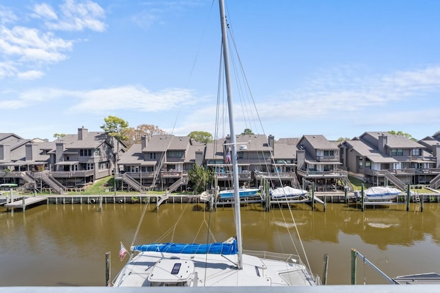 dock area with a residential view and a water view