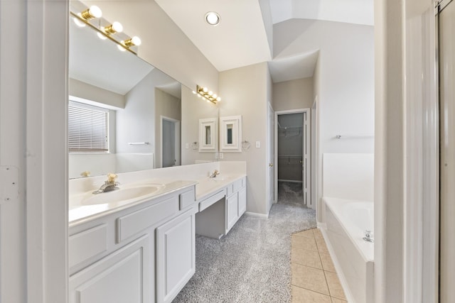 bathroom featuring double vanity, lofted ceiling, a garden tub, and a sink