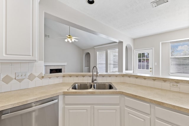 kitchen with visible vents, dishwasher, light countertops, and a sink