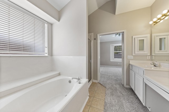 full bath featuring tile patterned flooring, a shower stall, baseboards, a garden tub, and vanity