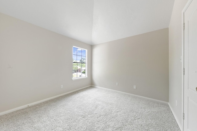 carpeted empty room with baseboards