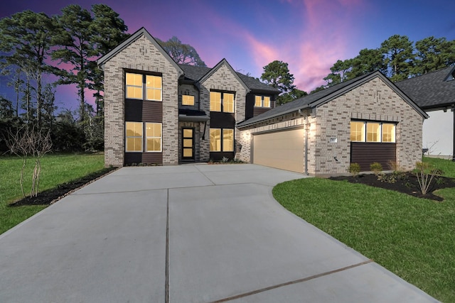 view of front facade with brick siding, an attached garage, concrete driveway, and a front lawn