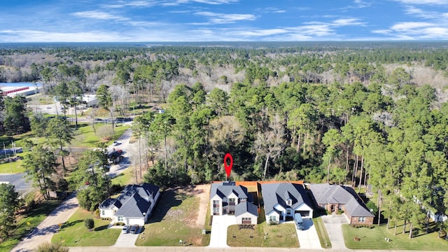 birds eye view of property featuring a wooded view