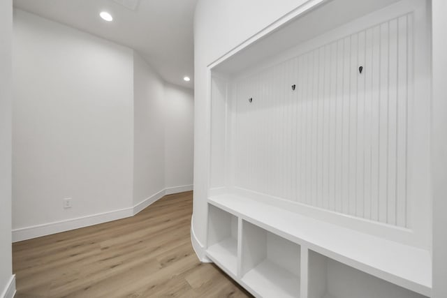 mudroom with recessed lighting, baseboards, and wood finished floors