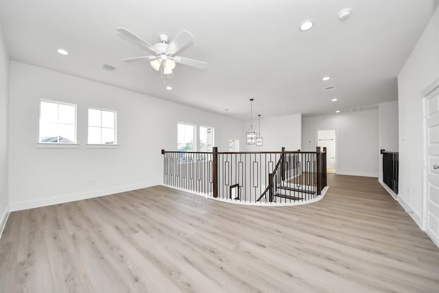 interior space with recessed lighting, visible vents, an upstairs landing, and light wood-style floors