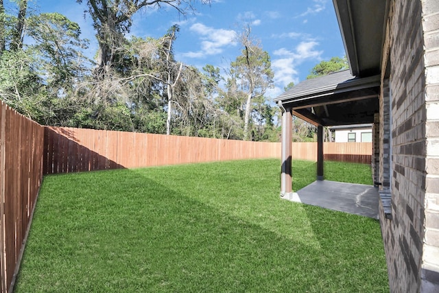 view of yard with a fenced backyard and a patio area