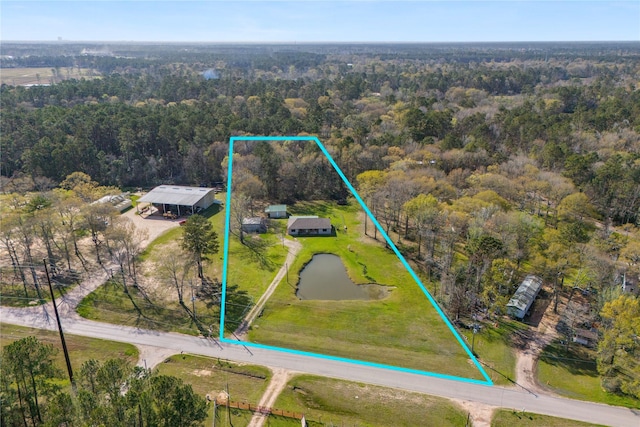 birds eye view of property featuring a view of trees