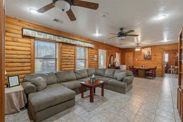 living room featuring visible vents and a ceiling fan