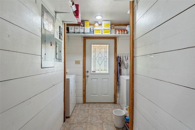 entryway featuring electric panel and wood walls