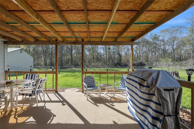 view of patio with outdoor dining space, a fenced backyard, and a grill