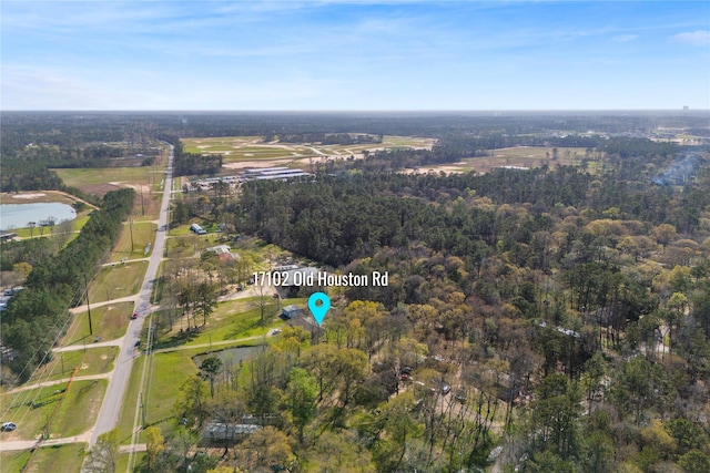 birds eye view of property with a forest view and a water view