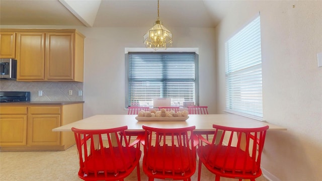 dining space featuring an inviting chandelier