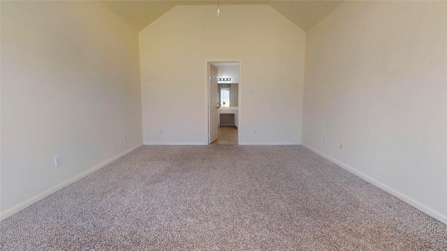 unfurnished room featuring baseboards, carpet floors, and vaulted ceiling