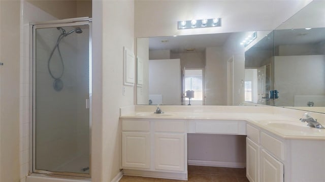 full bath featuring a sink, a stall shower, and double vanity