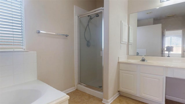 bathroom featuring a bath, tile patterned flooring, a shower stall, and vanity