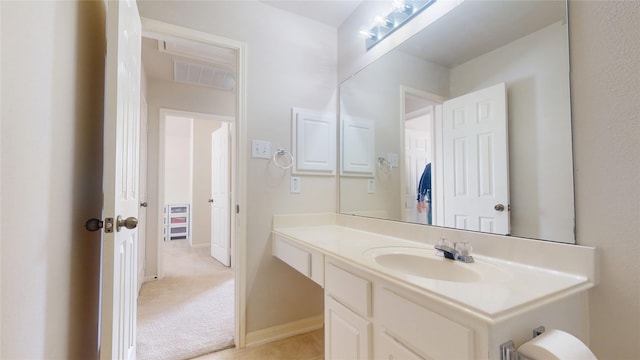 bathroom with visible vents, baseboards, and vanity