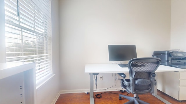 office area with baseboards and wood finished floors