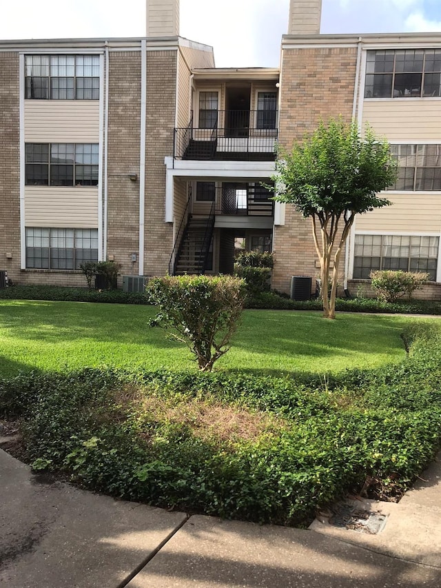 view of property featuring stairway and central AC