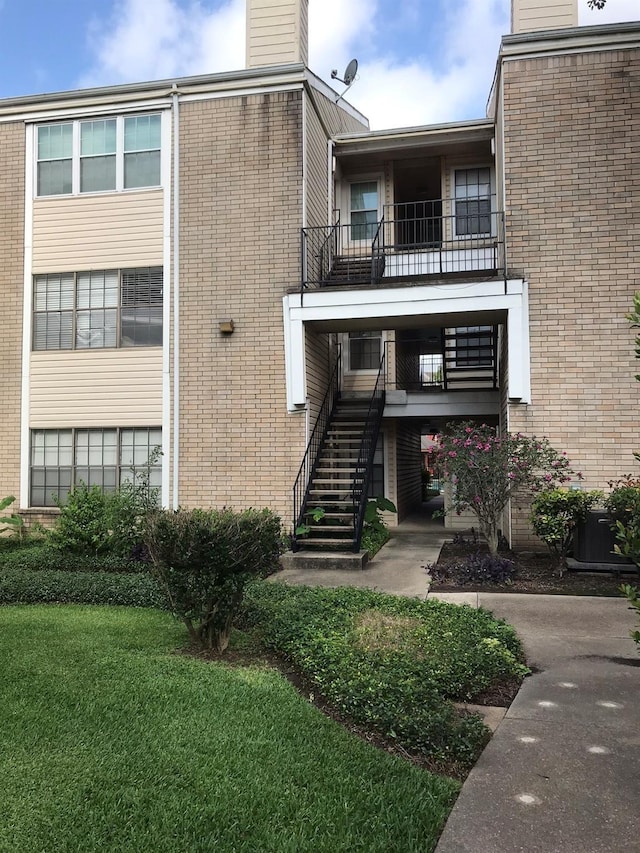 view of property with stairway and central AC