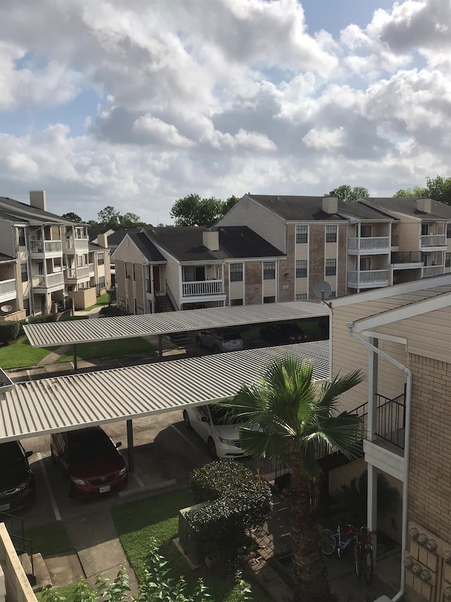 exterior space with a residential view and covered parking