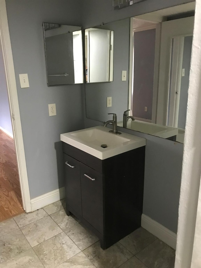 bathroom with vanity and baseboards