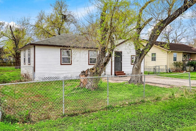 single story home with a fenced front yard, a front yard, and entry steps