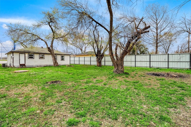 view of yard with fence and central AC