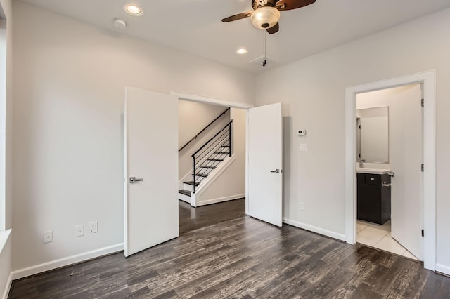 unfurnished bedroom featuring recessed lighting, baseboards, wood finished floors, and ensuite bathroom