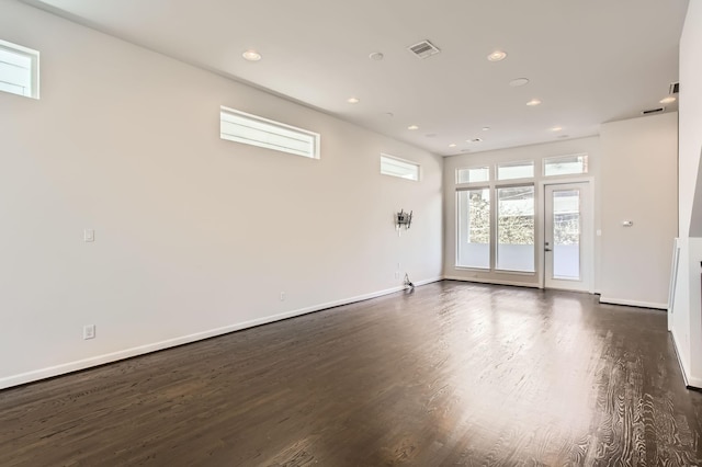 spare room with recessed lighting, dark wood-type flooring, and baseboards