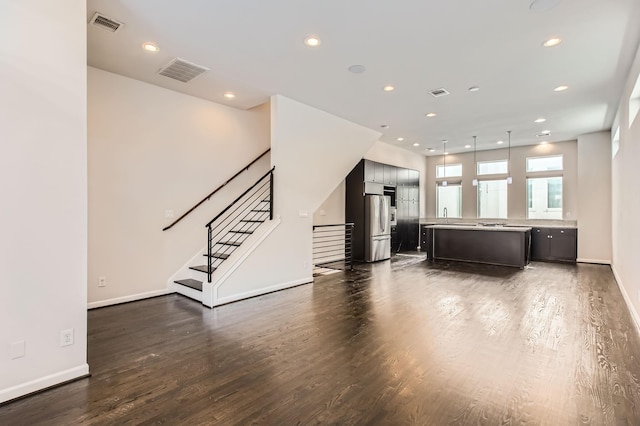 unfurnished living room featuring stairway, recessed lighting, visible vents, and dark wood-style flooring