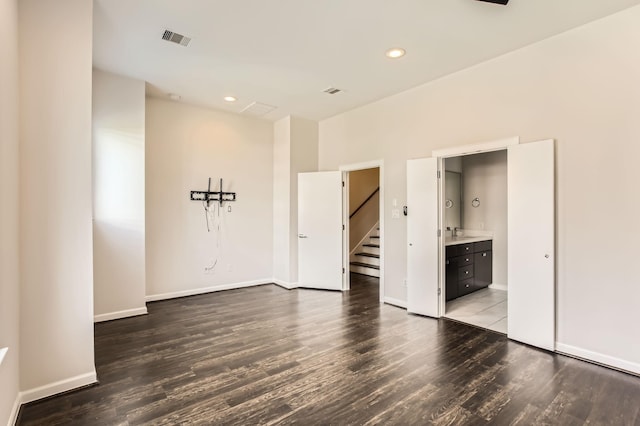 empty room with visible vents, recessed lighting, baseboards, and wood finished floors