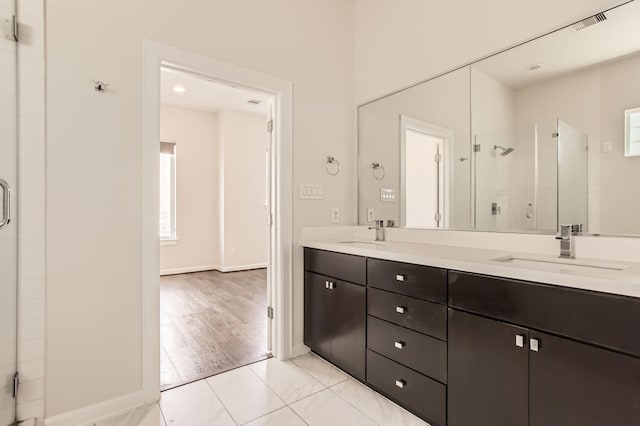 bathroom featuring a sink, visible vents, double vanity, and a shower stall