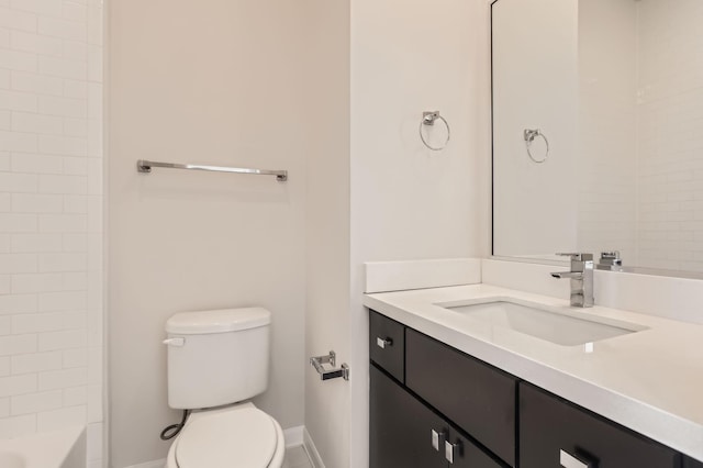 full bathroom with baseboards, toilet, and vanity