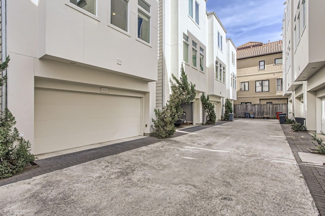 exterior space with a residential view and concrete driveway