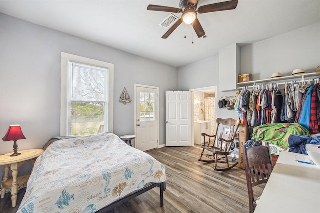 bedroom featuring visible vents, wood finished floors, and a ceiling fan