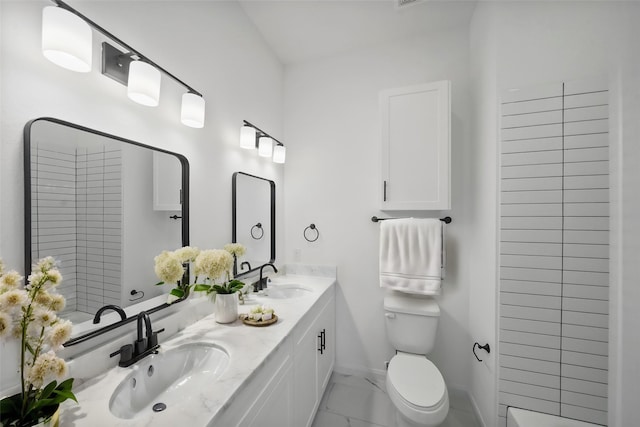 full bathroom featuring toilet, baseboards, marble finish floor, and a sink